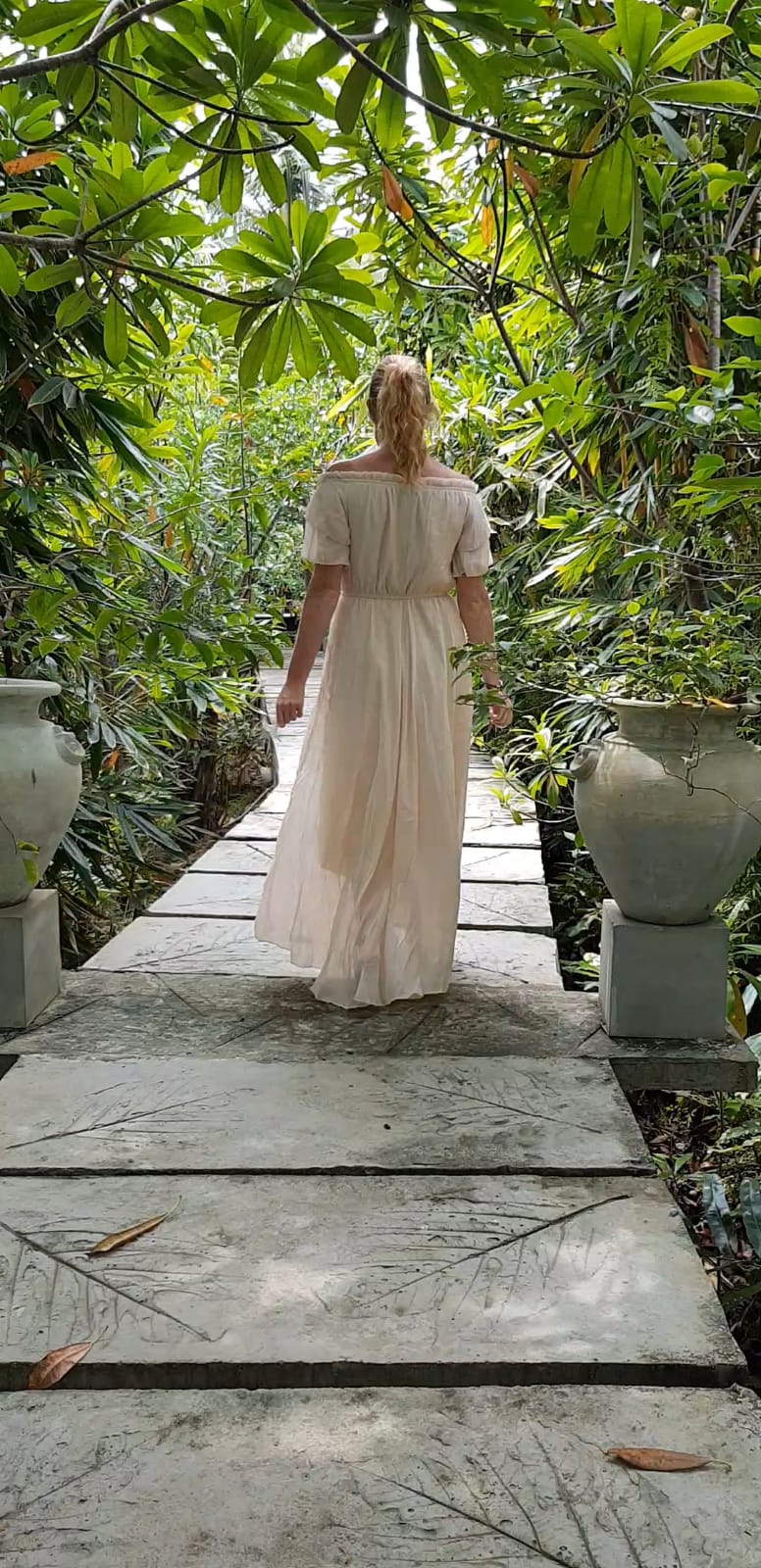 Lady walking through tropical plantation